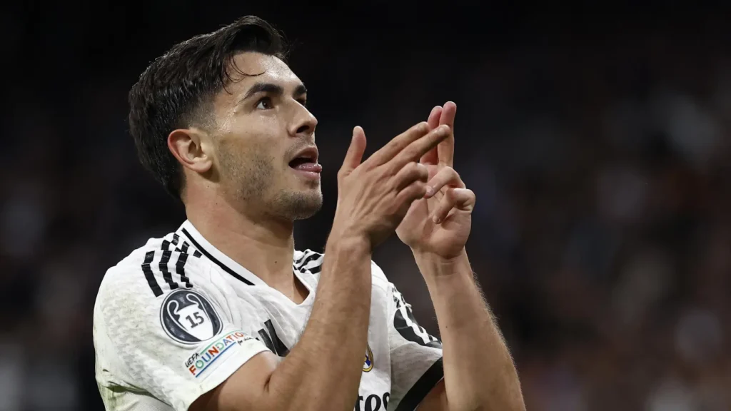 Brahim Díaz celebrates a goal for Real Madrid with a finger-guns gesture.