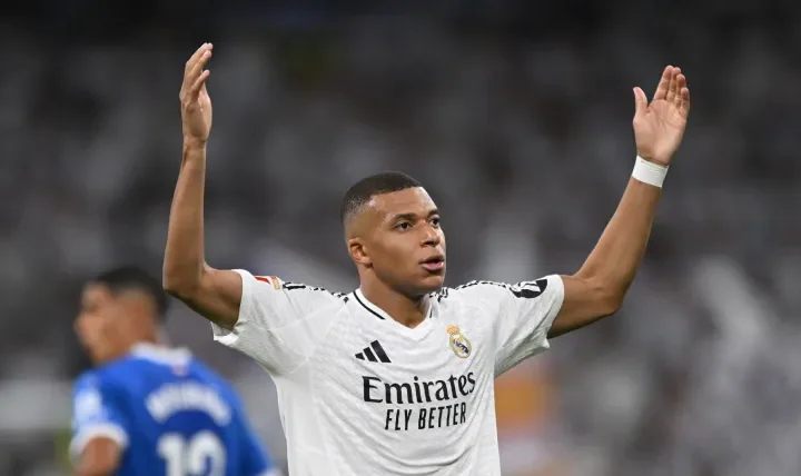 Mbappe celebrates with arms raised at the Bernabéu