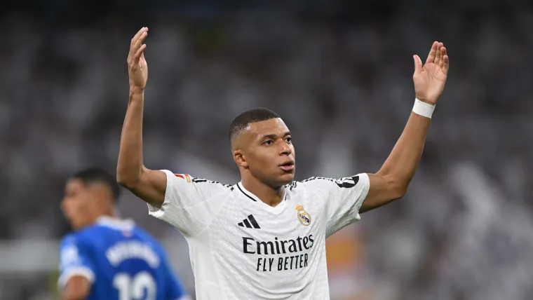 Mbappe celebrates with arms raised at the Bernabéu