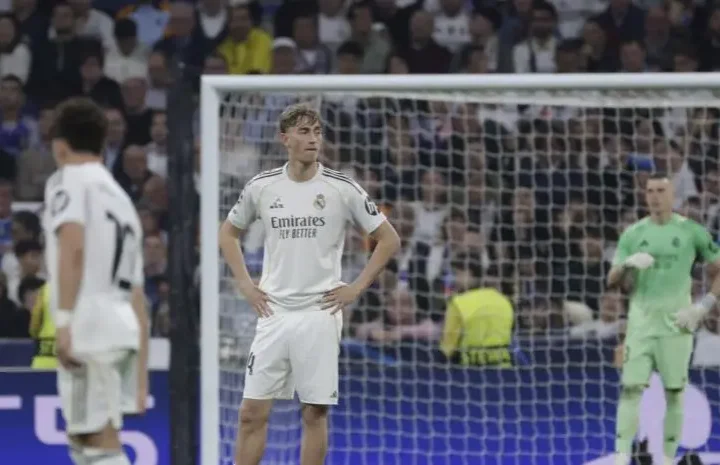 Dean Huijsen stands with hands on hips in front of goal during a tense match moment