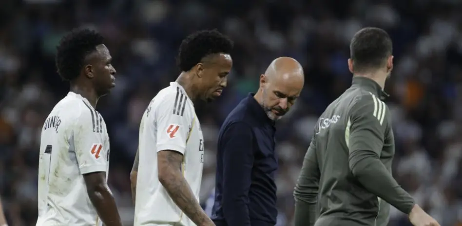 Real Madrid players and staff walk off the pitch during a match after an injury concern involving a defender.