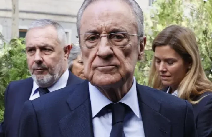 Senior Real Madrid Florentino Perez executive arrives outdoors alongside club associates before a public appearance