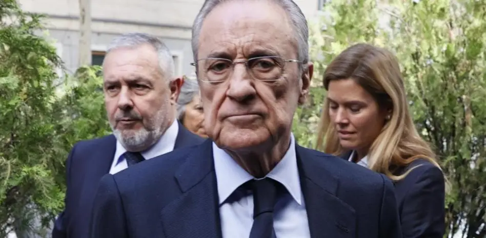 Senior Real Madrid Florentino Perez executive arrives outdoors alongside club associates before a public appearance