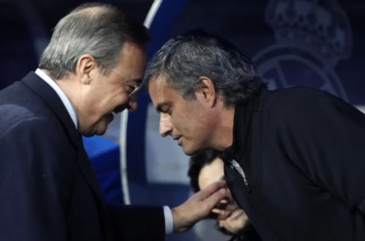 Two senior football figures greet at a Real Madrid event as coaching speculation around the club intensifies.