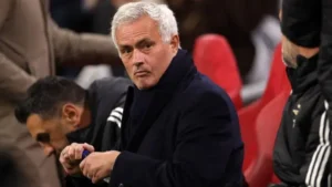 Football manager sitting on the bench during a match as Real Madrid coaching rumors intensify