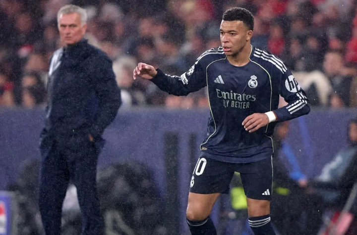 Real Madrid player during a match with a coach blurred in the background amid Jose Mourinho Real Madrid rumors