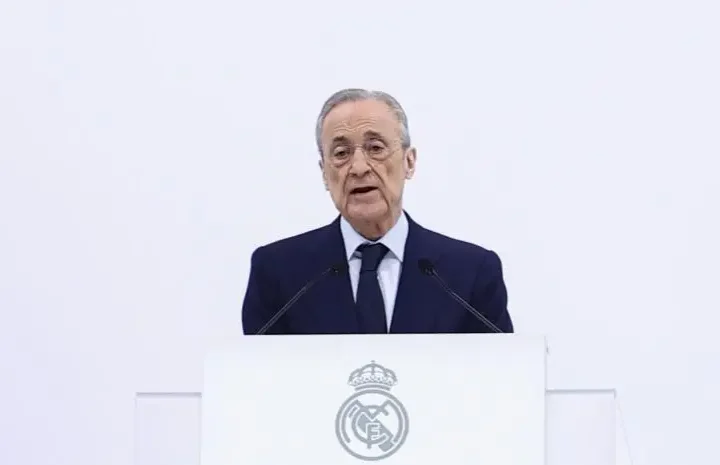 Club official speaks at a podium with the Real Madrid crest during an institutional appearance