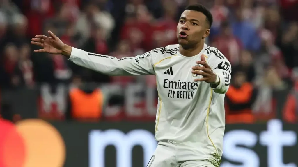Real Madrid player gestures with arms outstretched during a match.