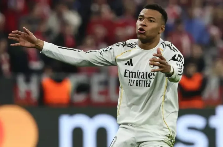 Real Madrid player gestures with arms outstretched during a match.