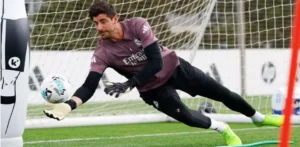 Real Madrid goalkeeper diving to save the ball during a training session at Valdebebas
