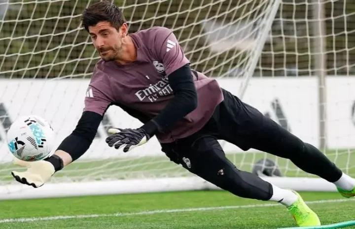 Real Madrid goalkeeper diving to save the ball during a training session at Valdebebas