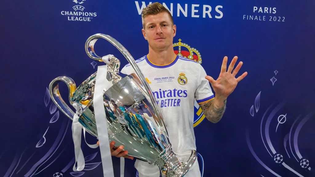 Toni Kroos Real Madrid return story showing a player with the Champions League trophy