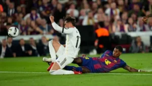 Barcelona vs Real Madrid result showing a Real Madrid attacker challenged by a Barcelona defender during a key Clasico moment
