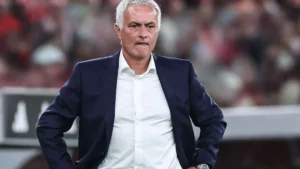Jose Mourinho Real Madrid return feature image showing a football coach standing on the touchline during a match