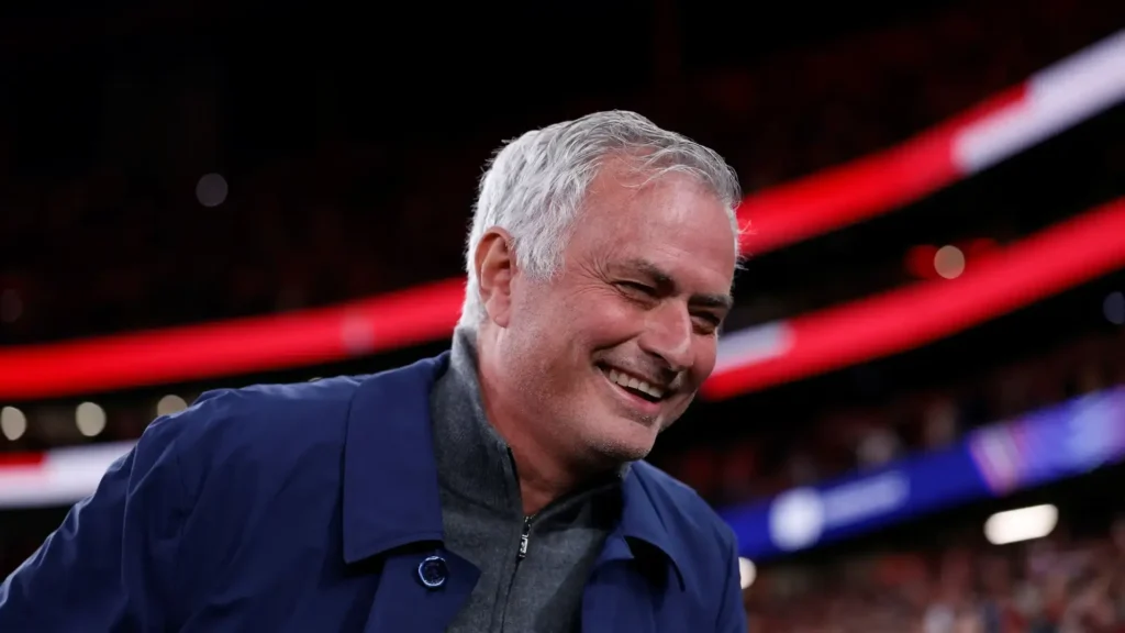 Smiling football coach in a stadium as Jose Mourinho Real Madrid return speculation intensifies