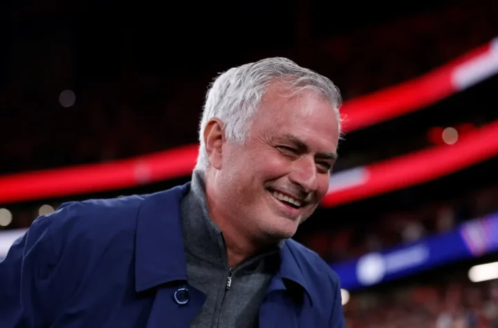 Smiling football coach in a stadium as Jose Mourinho Real Madrid return speculation intensifies