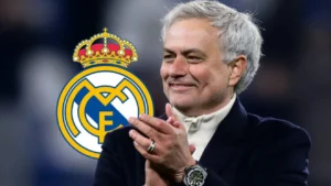 Jose Mourinho claps beside the Real Madrid crest as reports say his return to Real Madrid is reaching the final stages