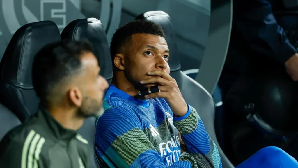 Real Madrid player sitting on the bench before kickoff during a tense moment