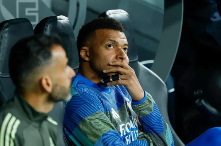 Real Madrid player sitting on the bench before kickoff during a tense moment