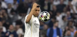 Mbappe El Clasico: Kylian Mbappe in a Real Madrid shirt watches the ball closely during a match at the Bernabeu