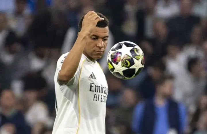 Mbappe El Clasico: Kylian Mbappe in a Real Madrid shirt watches the ball closely during a match at the Bernabeu