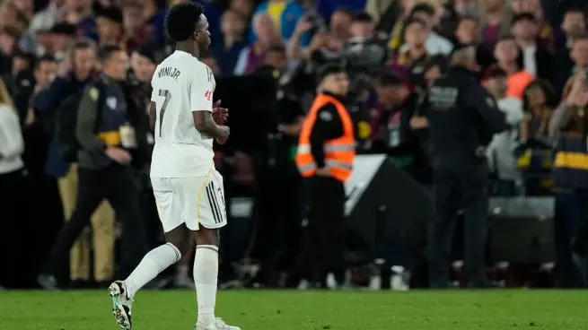 Real Madrid congratulates Barcelona after the final whistle as a Real Madrid player walks alone on the pitch following the Clasico loss