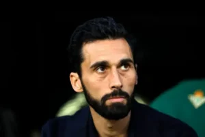 Real Madrid dressing room crisis image showing a serious bearded man on the bench during a tense moment