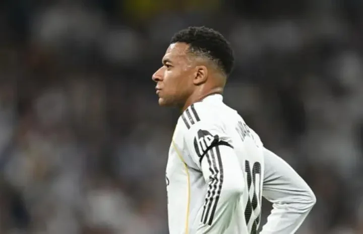 Real Madrid fans want Mbappe sold story image showing a Real Madrid player standing on the pitch during a tense moment