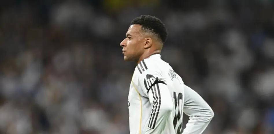 Real Madrid fans want Mbappe sold story image showing a Real Madrid player standing on the pitch during a tense moment