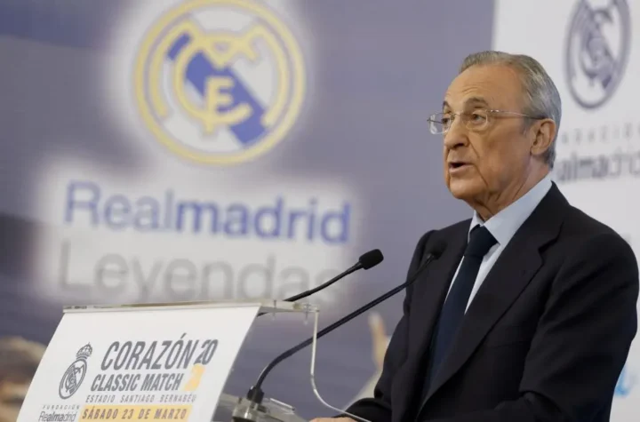 Real Madrid transfer news image showing a club official speaking at a podium in front of a Real Madrid backdrop