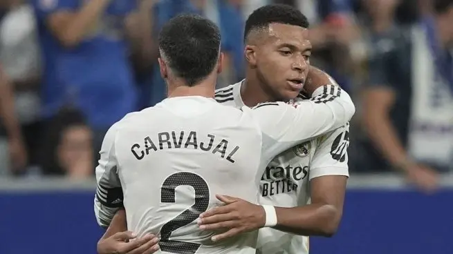 Two Real Madrid players embrace during a match as the Real Madrid vs Oviedo squad is confirmed