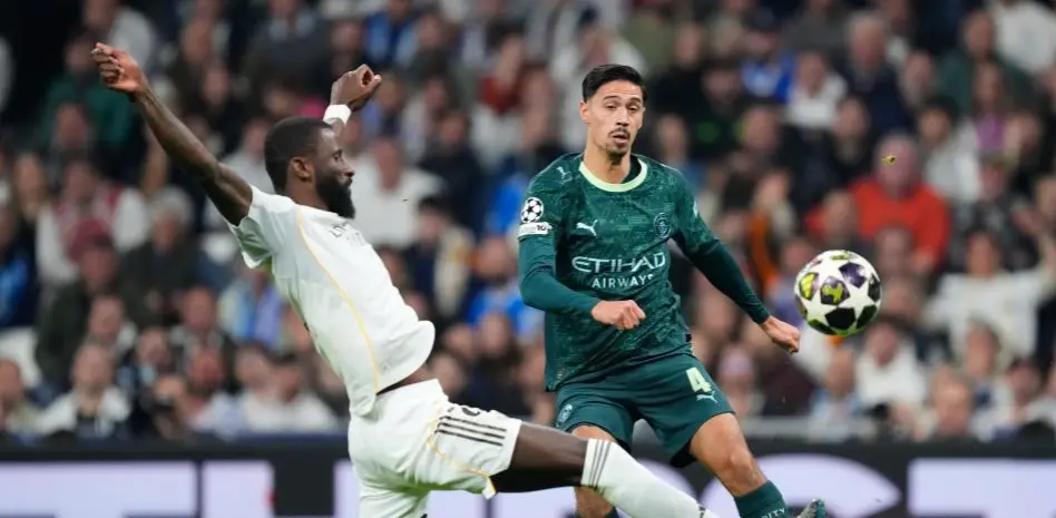 Tijjani Reijnders Real Madrid story image showing a Manchester City player challenged by a Real Madrid defender during a match