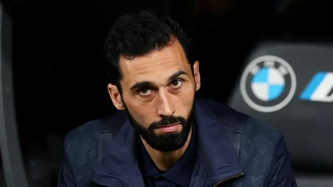 Who is Álvaro Arbeloa feature image showing a serious bearded man seated on the bench
