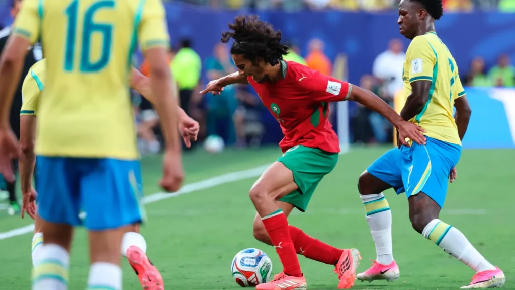 Morocco player dribbling against Brazil players during a World Cup match