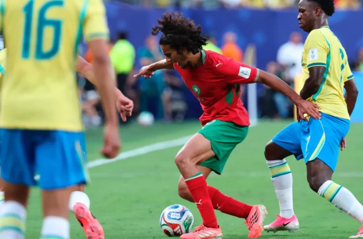 Morocco player dribbling against Brazil players during a World Cup match