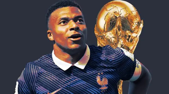 France player in a dark blue national team shirt with the World Cup trophy in the background