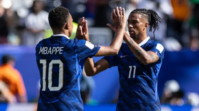 Two France players celebrate together during a match