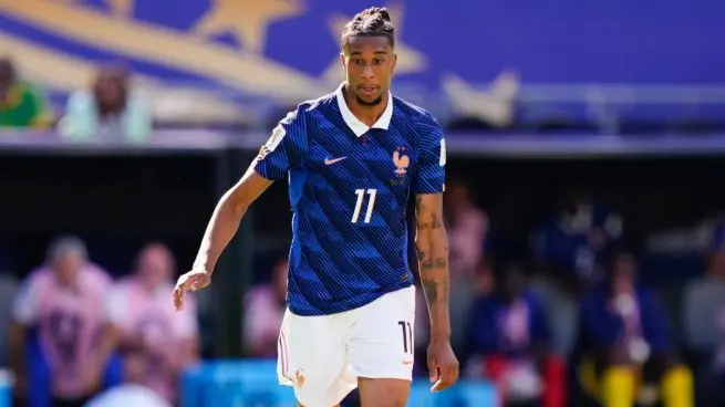 France player in a dark blue national team kit during a match