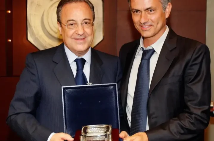 Real Madrid transfer news featured image showing two men in suits holding a presentation piece at a club event
