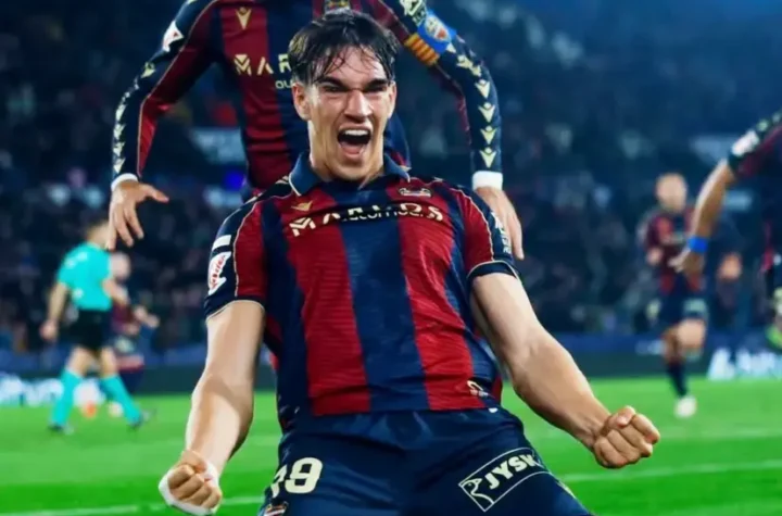 Carlos Espí Real Madrid featured image showing a young striker celebrating a goal during a league match