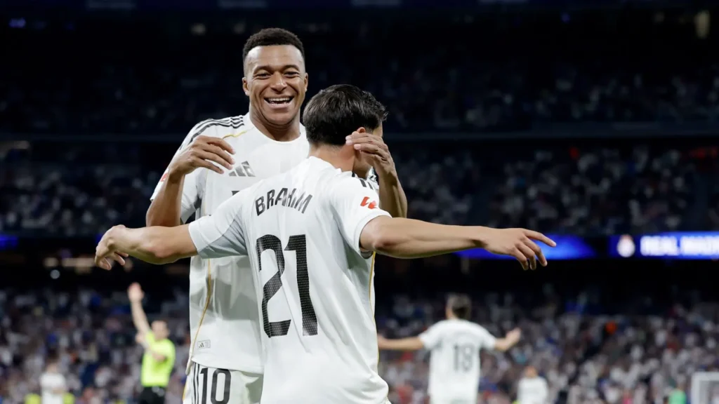 Two Real Madrid players celebrating together during a match