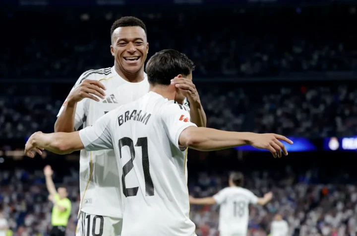 Two Real Madrid players celebrating together during a match