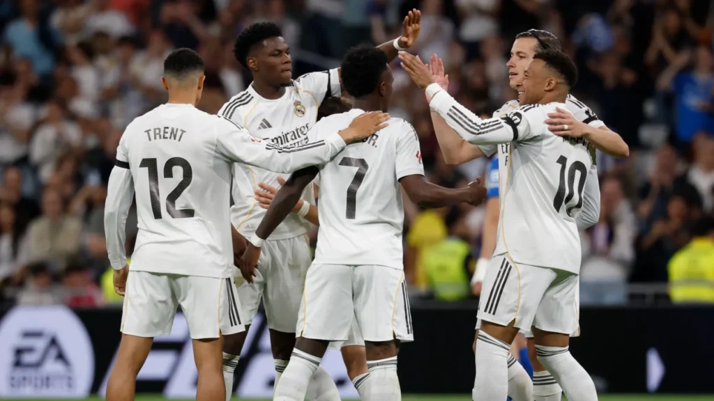 Real Madrid record revenue featured image showing the team celebrating together during a match