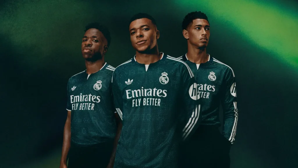 Real Madrid second kit in dark green shown on three players during the 2026-27 away kit launch