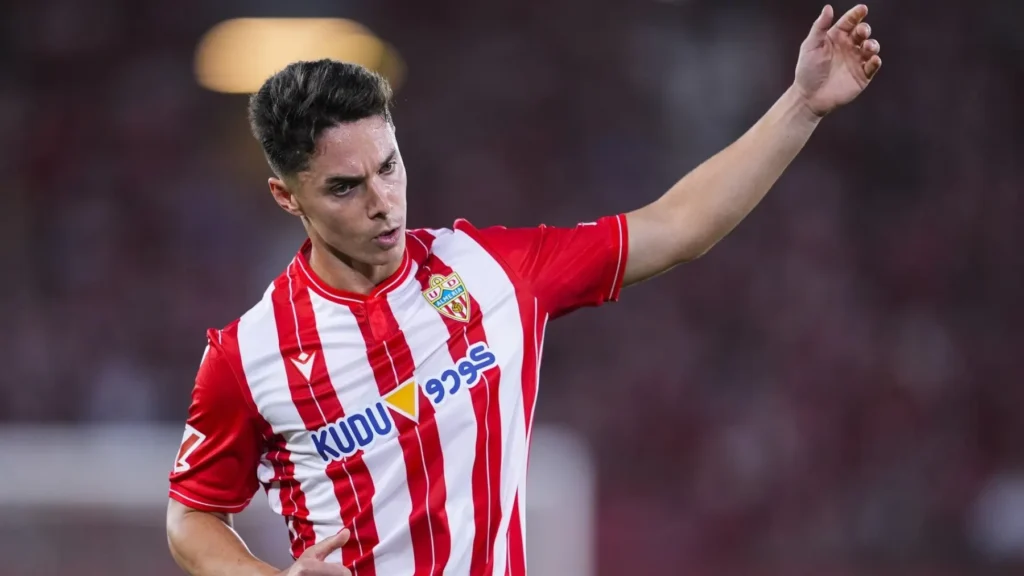 Player in an Almería kit raising his arm during a match