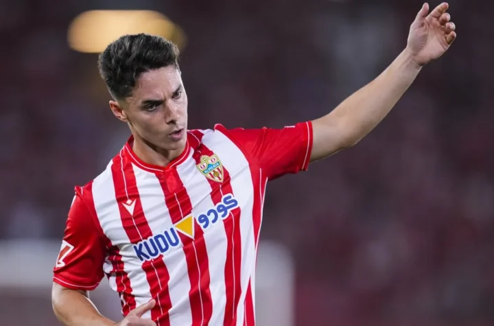 Player in an Almería kit raising his arm during a match